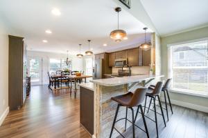 an open kitchen and dining room with bar stools at Deck and Mtn Views Riverfront Cullowhee Home in Cullowhee