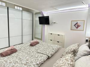 a bedroom with a bed with two pink pillows at Budapest City center perfect location in Budapest