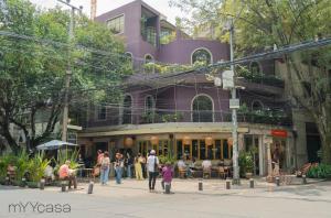 a group of people walking down a street in front of a building at Nuevo Leon PH - Cozy & Renovated PH with Exclusive Design in Condesa in Mexico City