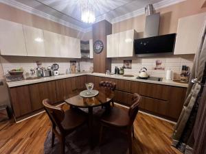 a kitchen with a table and chairs in a kitchen at Park Azure 463 in Baku