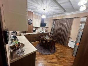 a kitchen with a table and a dining room at Park Azure 463 in Baku