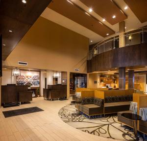 a lobby of a hotel with a restaurant at Best Western Plus Franciscan Square Inn & Suites Steubenville in Steubenville