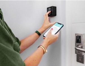 a person holding a cell phone in front of a door at Bretema in Lugo