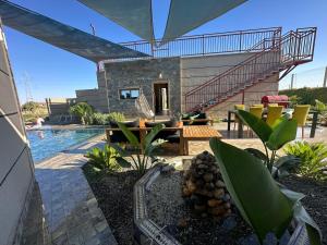 a house with a swimming pool and a patio at Ferme Marsa in Guercif