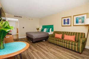 a living room with a couch and a bed at Ocean view Balcony Walk to beach PW722 in Honolulu