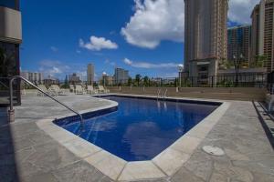 a swimming pool in the middle of a city at Ocean view Balcony Walk to beach PW722 in Honolulu
