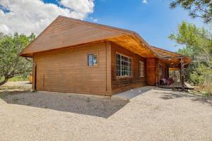 a small wooden building with a porch on top at A Cozy Cabin Escape in Tijeras-Hot Tub-Game room-Pet Friendly! in Tijeras