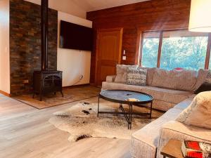 a living room with a couch and a fireplace at A Cozy Cabin Escape in Tijeras-Hot Tub-Game room-Pet Friendly! in Tijeras