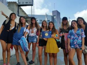 un grupo de chicas posando para una foto con un portátil en HOSTAL SAN MARINO, en Manta