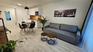 een woonkamer met een bank en een tafel bij 2 room Apartment with terrace, 2AK in Bratislava