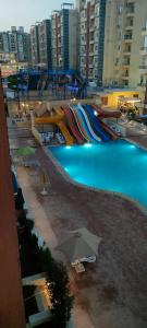 a water park with a slide and an umbrella at الساحل الشمالي in El Alamein