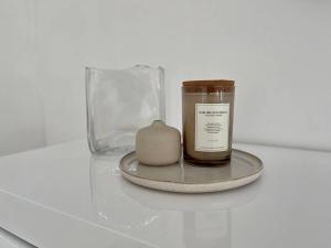 a candle in a glass jar on a table at Stylish Lagoon front Villa by Casa Paraiso in Cancún