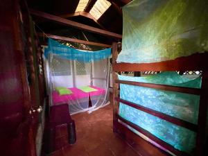 a room with a bunk bed in a house at Palmeras del Río HOTEL in La Viña