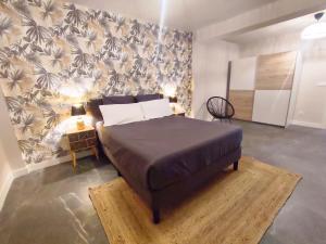 a bedroom with a large bed with a wall at Apartamento Suite 48- Recién reformado in Avilés