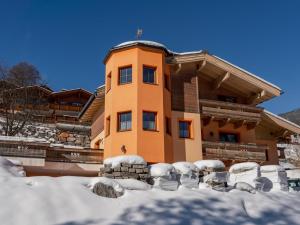 a house with snow in front of it at Zirmblick in Saalbach-Hinterglemm