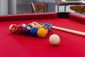 a group of pool balls on a red pool table at The Cherry Suites - Chinatown in Philadelphia