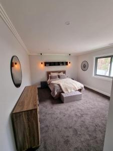 a bedroom with a bed and a table in it at Blue Mountains Sweet Retreat in Leura