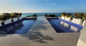 a swimming pool on the roof of a building at Departamento en Manta Edificio Poseidon in Manta +26 photos