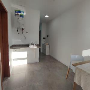 a living room with a counter and a white wall at Villa Sarita 3D in Posadas +27 photos