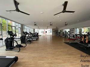 a gym with rows of treadmills and elliptical machines at Reylin Alanis Suite // Free Wifi & Netflix // Airport Shuttle Service in Sepang