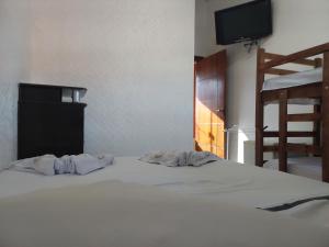 a bedroom with a bed with two pillows on it at Pousada Recanto Paraíso Família in Caldas Novas