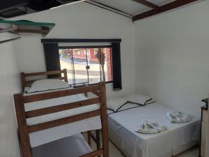 two bunk beds in a room with a window at Pousada Recanto Paraíso Família in Caldas Novas +24 photos
