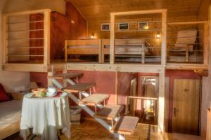 a room with a table and some bunk beds at Tourist Farm Kranjc in Kobarid