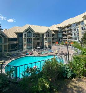 an apartment complex with a swimming pool and a resort at The Woodrun Lodge by Whiski Jack in Whistler