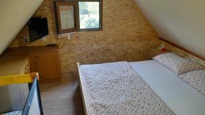 a small bedroom with a bed and a window at Family friendly house with a parking space Zdihovo, Gorski kotar - 20491 in Bosiljevo