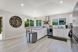a kitchen with white cabinets and a sink at Port Royal Retreat in Bermuda Dunes