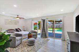 a bedroom with a bed and a living room at Port Royal Retreat in Bermuda Dunes