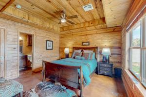 a bedroom with a bed in a log cabin at Executive Cabin in Bentonville