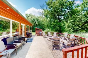 a patio with chairs and tables and windows at Executive Cabin in Bentonville