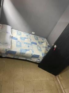 een bed met een blauw en wit dekbed in een kamer bij Hotel Rio Puntarenas in Puntarenas