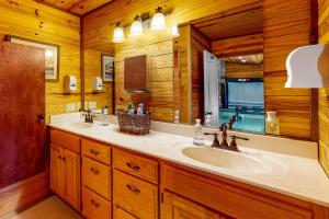 a bathroom with a sink and a mirror at Cabin 1 & 2 in Bentonville