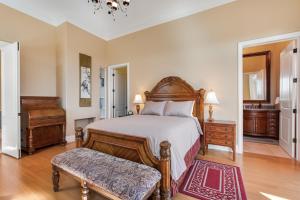 a bedroom with a bed and a bench in a room at Castle on the Hill in Maple Grove Beach