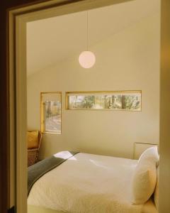 a bedroom with a white bed and a window at Colorado Lodge in Big Bear Lake