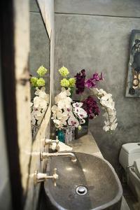 a bathroom with a sink with flowers and a mirror at RiverView Gardens in Ubud +57 photos