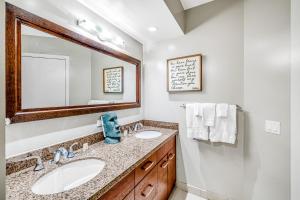 a bathroom with two sinks and a mirror at Allure Waikiki 2311 - 30 Night Minimum in Honolulu