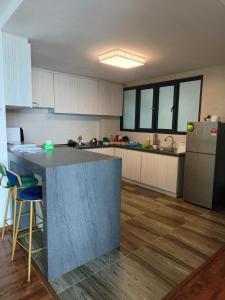 a kitchen with a counter and a refrigerator at Littleching vivacity jazz 3 @2bedroom in Kuching