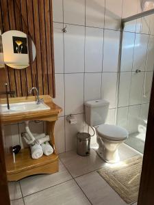 a bathroom with a toilet and a sink and a shower at Pousada Serra Geral in Cambara do Sul +110 photos
