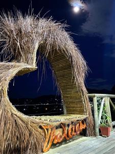 a straw chair sitting on a deck at night at Eco Hotel The View in El Peñol