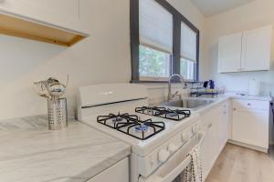 a white kitchen with a stove and a sink at The Wilsonia in Memphis