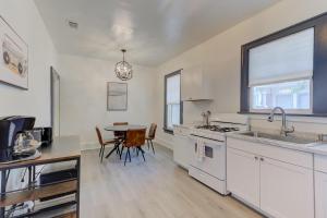 a kitchen with white cabinets and a table with chairs at The Wilsonia in Memphis