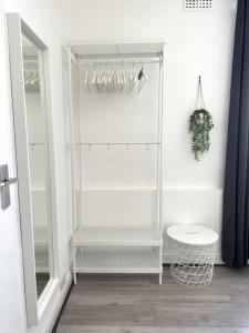 a white bathroom with a toilet and a mirror at Stunning 2-bed apt near central London. in London
