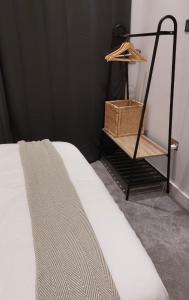 a bedroom with a bed and a shelf with a basket at Modern 2bed Sutton in Sutton
