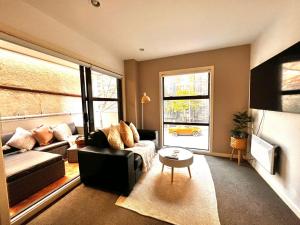a living room with a couch and a window at Studio Apartment in Auckland CBD in Auckland