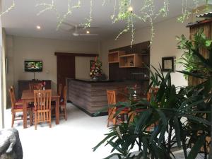 a dining room with a table and chairs at Teja Home Stay in Ubud