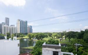 a view of the city from the balcony of a building at District Inn in Manila