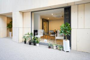 a balcony with potted plants in front of a building at SimpleStay Hotel in Jongno in Seoul